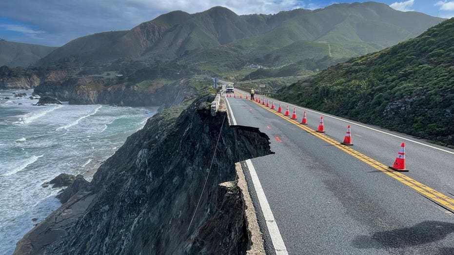 Authorities escort cars around part of California’s Highway 1 that crumbled into ocean