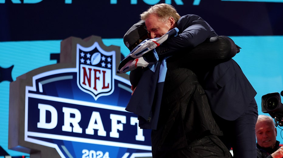 Titans draft pick JC Latham gives Roger Goodell bear hug on draft stage despite commish's recent back surgery