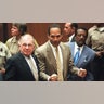 Murder defendant O.J. Simpson listens to the not guilty verdict with his attorneys F. Lee Bailey and Johnnie Cochran Jr