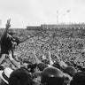 O.J. Simpson, USC's running back gives the victory sign as he is carried off the field by hundreds of cheering fans