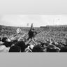 O.J. Simpson, USC's running back gives the victory sign as he is carried off the field by hundreds of cheering fans