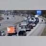 A motorcycle cruises down the breakdown lane as solar eclipse seekers and drivers head north on Route 93 in heavy traffic hours before an afternoon total eclipse