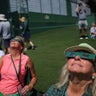 Viewers use special protective glasses to observe a total solar eclipse during a practice round at The Masters Golf Tournament