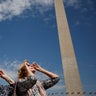 Women view the solar eclipse outside the National Monument