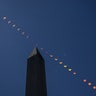 This composite image of multiple exposures shows the progression of a partial solar eclipse over the Washington Monument