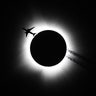 An airplane passes near the eclipse during the Hoosier Cosmic Celebration at Memorial Stadium