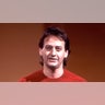 Comedian Joe Flaherty wears red shirt.