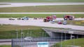 Police and firefighters stand on a runway access road at Franz-Josef-Strau&szlig; Airport around climate activists who have stuck themselves there.  Climate protection activists paralyzed Munich Airport early Saturday morning. The activists had reached the inner area of the airport grounds. According to their own statements, members of the so-called Last Generation had planned to enter the airport grounds in order to block at least one of the two runways.