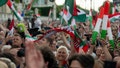People wave Hungarian national flags next to the Danube river, in Budapest, Thursday May 30, 2024, where politicians took to the debate stage ahead of the European Parliament elections. The debate, where the leaders of 11 party lists running in the June 9 elections, is the first to be broadcast by Hungarys public media since 2006, while protesters outside demonstrated against the public broadcaster that is hosting the event.