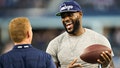 LeBron James is greeted by Head coach Jason Garrett of the Dallas Cowboys before a game against the New York Giants at AT&amp;T Stadium on September 8, 2013 in Arlington, Texas.