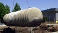 Workers remove a 10,000-gallon underground gasoline storage tank to be replaced with a new tank at a gas station in Sacramento, California, on May 23, 2003. Environmental experts say even a pinprick-sized hole in an underground tank can send 400 gallons of fuel a year into the ground, polluting soil and water.