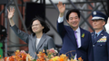 Taiwan's new President Lai Ching-te, right, and former President Tsai Ing-wen wave during Lai's inauguration ceremonies in Taipei, Taiwan, Monday, May 20, 2024. Lai in his inauguration speech has urged China to stop its military intimidation against the self-governed island Beijing claims as its own territory.