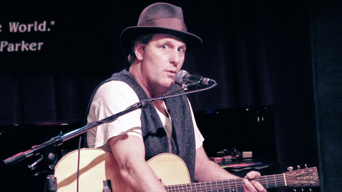 A photo of Jeff Daniels playing guitar