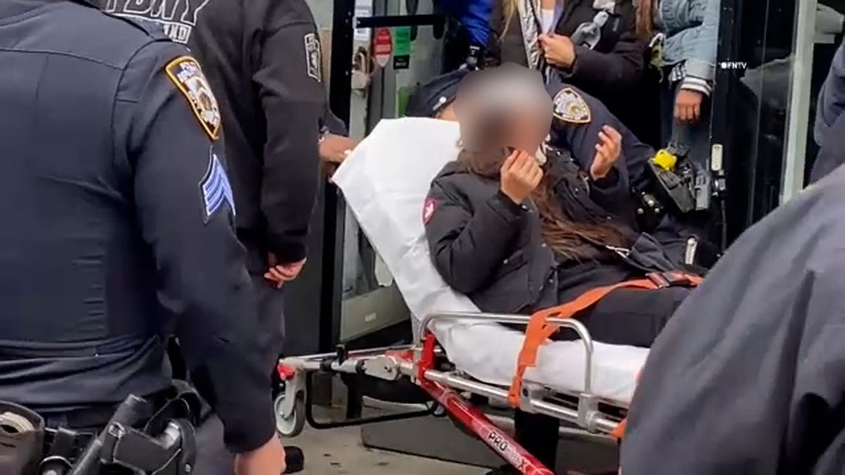 Young victim is placed in ambulance after brutal assault near NYC subway