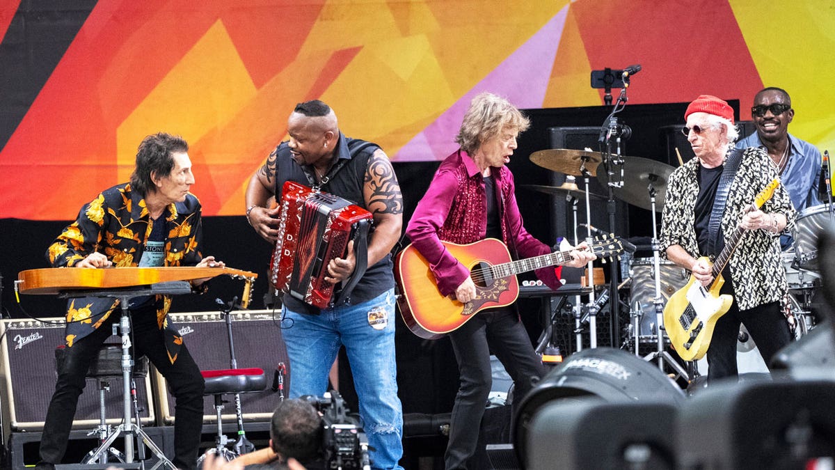 Ron Wood, left, Dwayne Dopsie, Mick Jagger, Keith Richards and Steve Jordan perform with the Rolling Stones during the New Orleans Jazz & Heritage Festival