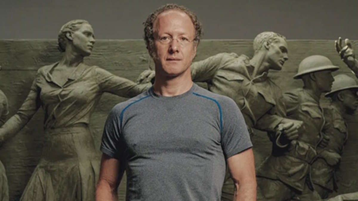 sabin howard stands in front of his WWI sculpture