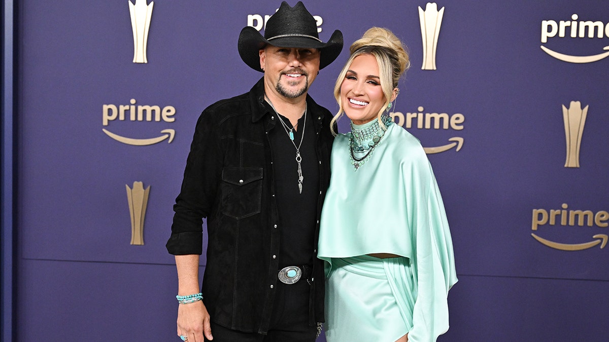 Jason Aldean and his wife on the ACM red carpet