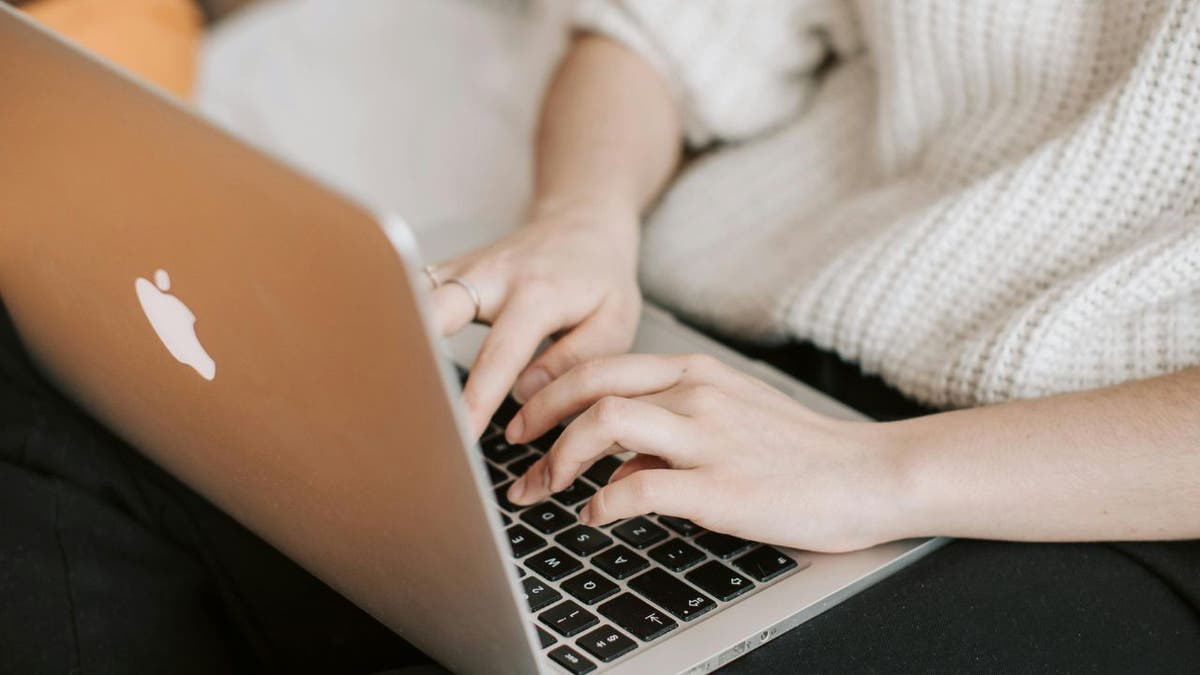 WOMAN Typing on laptop