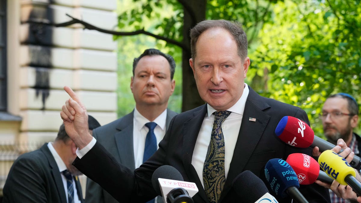 Israel's Ambassador to Poland, Yacov Livne, left, and U.S. Ambassador to Poland Mark Brzezinski, speak to reporters at a news conference in front of the No?yk Synagogue