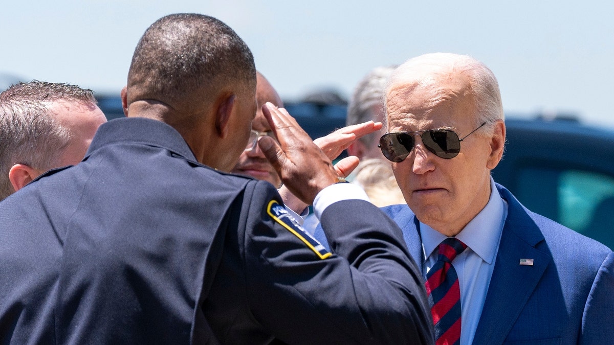 President Joe Biden salutes Charlotte-Mecklenburg Police Department Chief Johnny Jennings, arsenic he arrives connected Air Force One astatine Charlotte Douglas International Airport, Thursday, May 2, 2024, successful Charlotte, N.C.