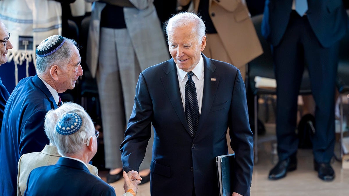 Biden shakes hands astatine  Holocaust Remembrance ceremony
