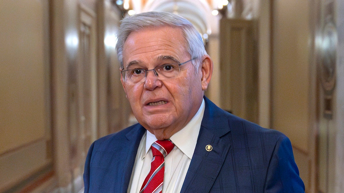 Menendez in Capitol hallway with distressed look on his face