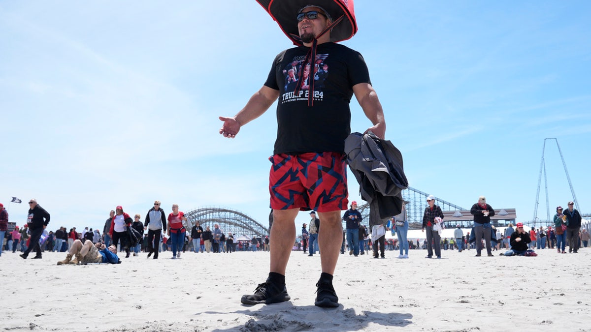 Anthony Pahopin wears an oversized Donald Trump cap before the former president's campaign in Wildwood, Saturday.