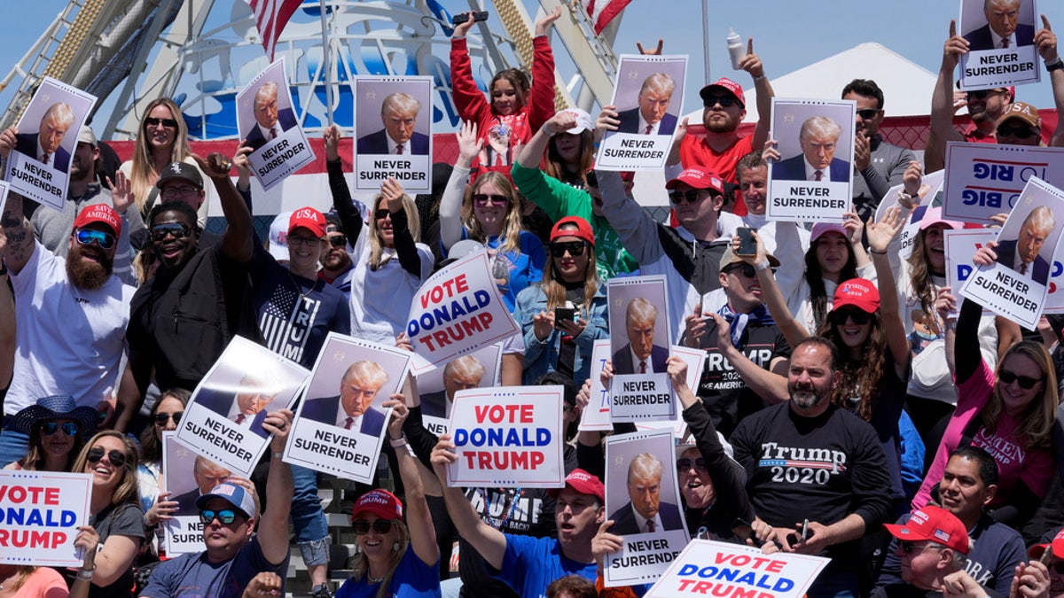 People cheer ahead of a campaign rally for presidential candidate former President Trump in Wildwood, Saturday.