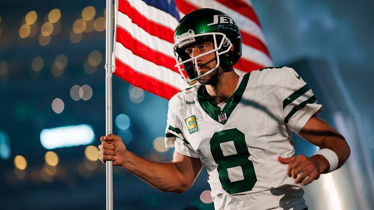 Aaron Rodgers carries the American flag