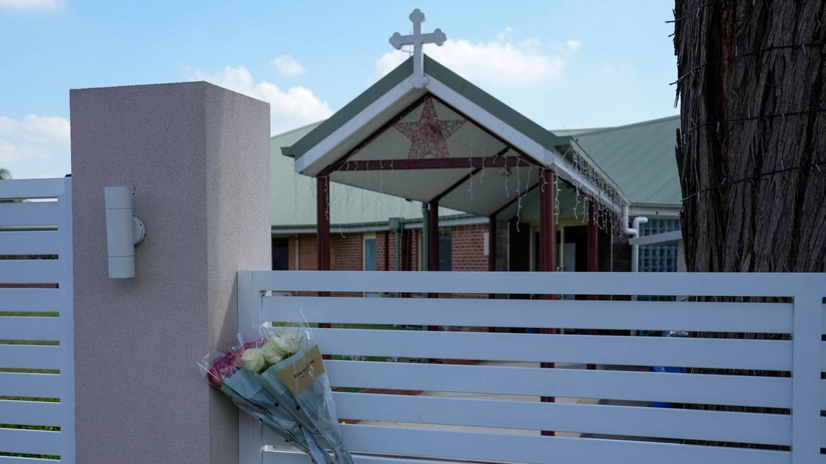 Flowers sit on a fence outside the Christ the Good Shepherd church in suburban Wakely in western Sydney, Australia