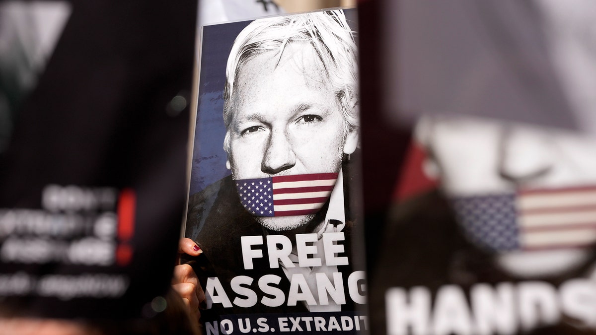 Julian Assange trial in London could decide whether the WikiLeaks founder is extradited to the US Protesters hold placards outside the High Court in London ahead of Julian Assange's hearing
