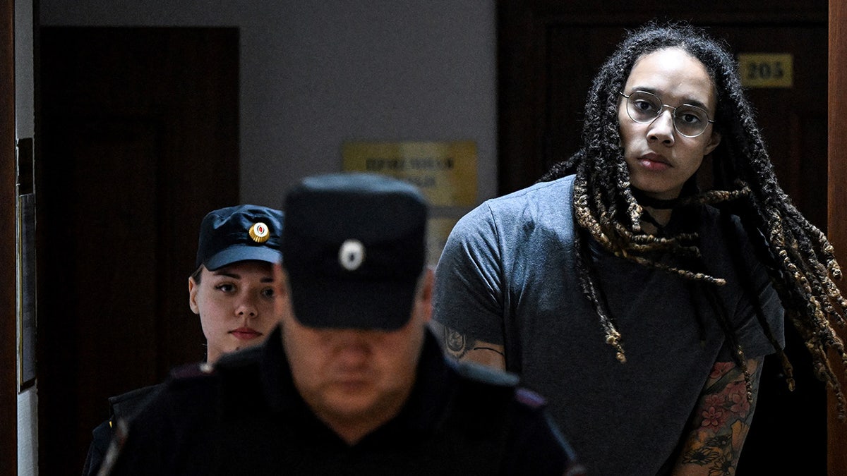 Brittney Griner, who was detained at Moscow's Sheremetyevo Airport and later charged with illegal possession of cannabis, is escorted to the courtroom to hear the court's final decision in Khimki, outside of Moscow, on Aug. 4, 2022.