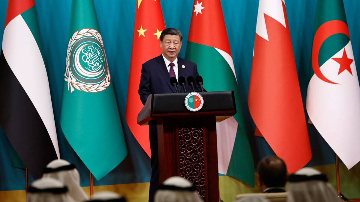 Chinese President Xi Jinping stands in front of six flags as he delivers a speech at the opening ceremony of the 10th ministerial meeting of the China-Arab States Cooperation Forum at the Diaoyutai State Guesthouse in Beijing.