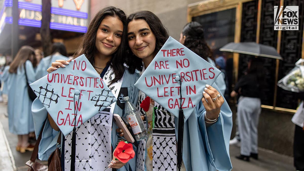 Columbia graduate in cap and gown outside Radio City Music Hall