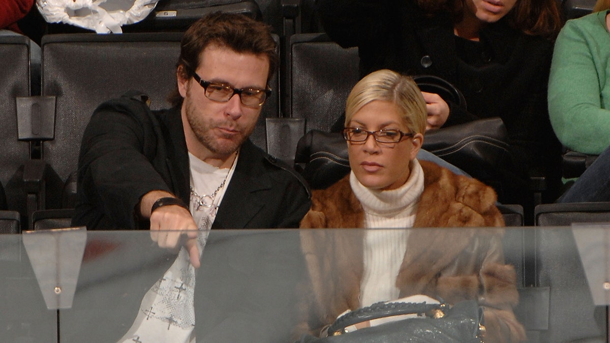 Dean McDermott and Tori Spelling attend a NHL game