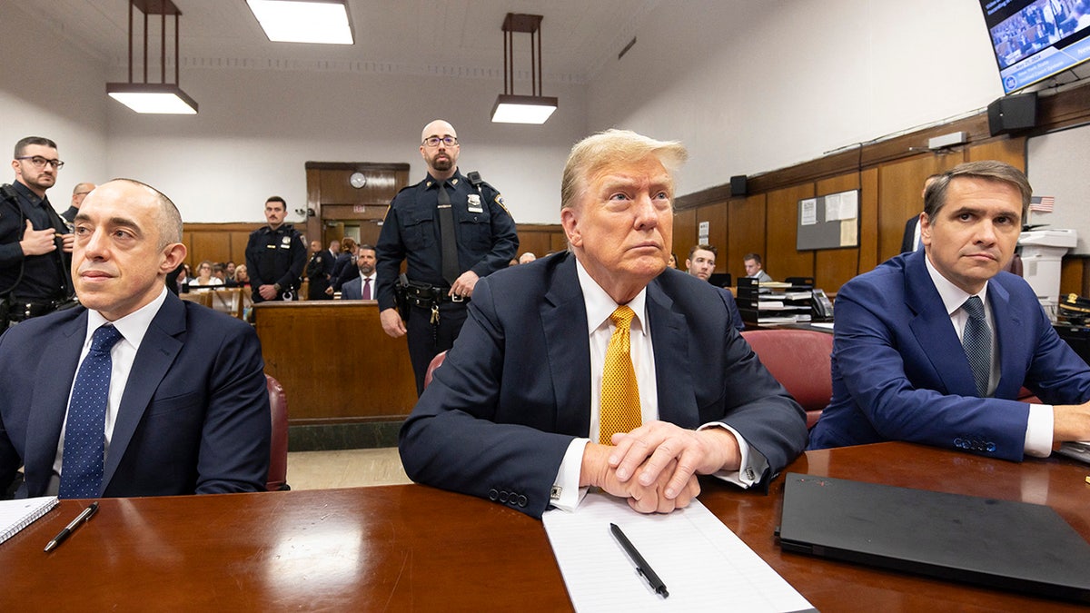 Donald Trump sits in the courtroom during the money trial