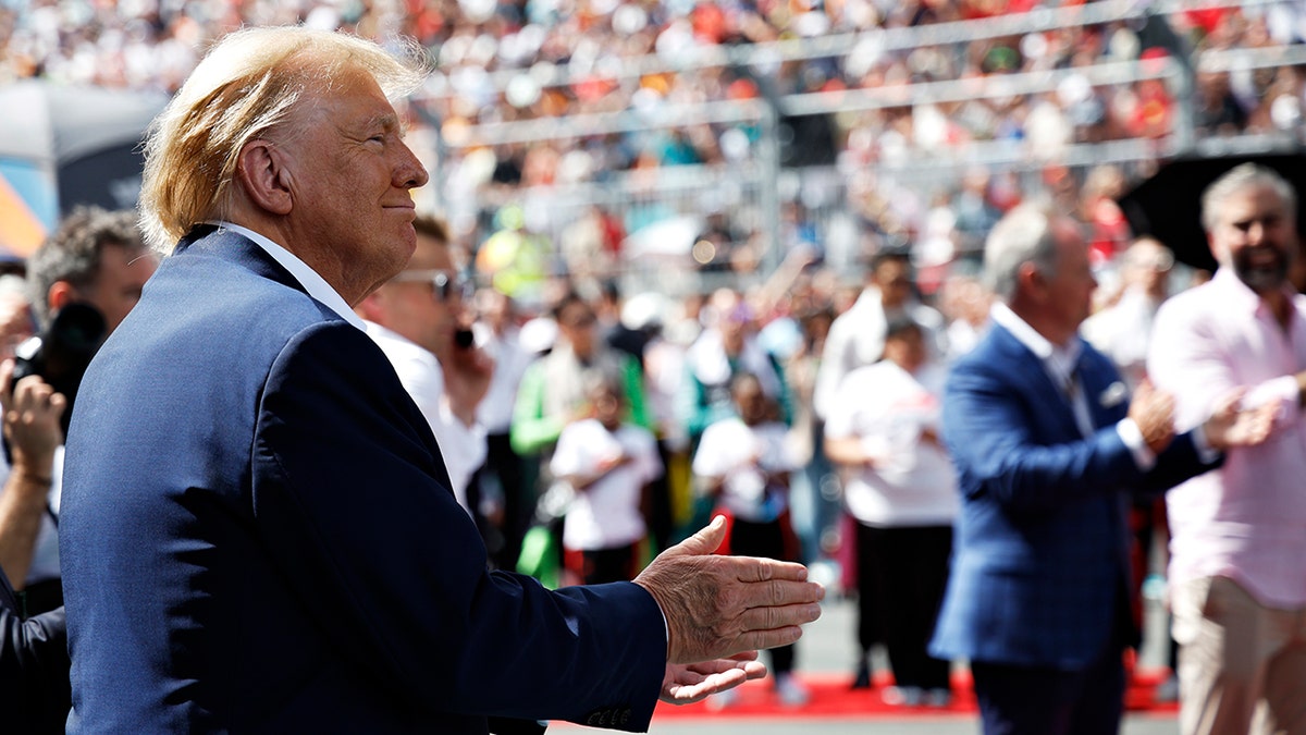 Donald Trump waves to crowd, salutes during national anthem at F1 Miami
