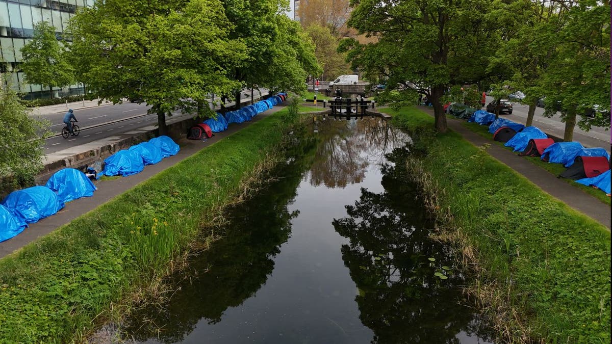 Dozens of migrant tents along its Grand Canal