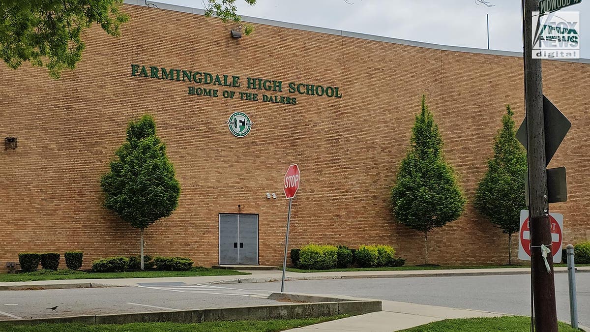 Exterior shot of a brick building with a sign reading, Farmingdale High School: Home of the Dalers on it.