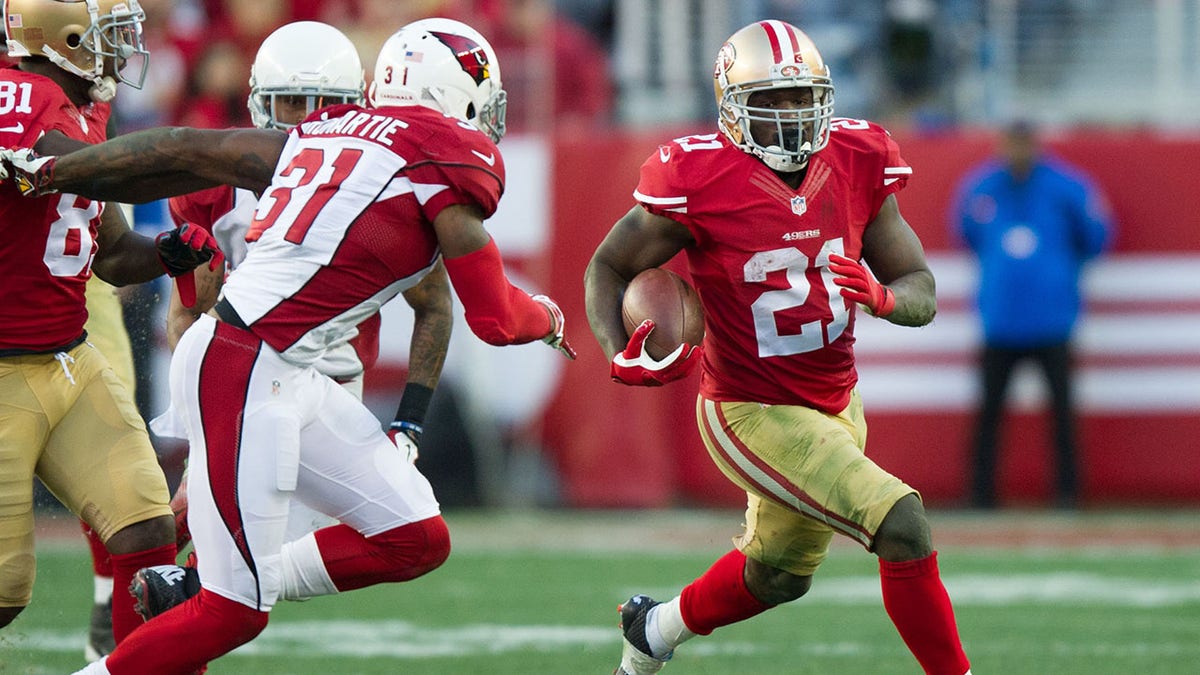 Frank Gore runs with the football