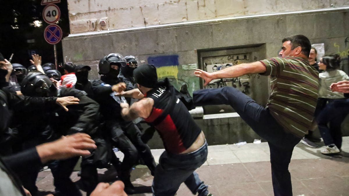 Demonstrators in Georgia scuffle with riot police during an opposition protest against "the Russian law"
