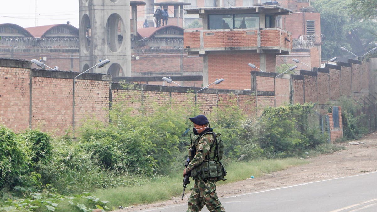 A soldier patrols outside the Modelo prison in Cucuta, Columbia, during a riot on March 24, 2020.