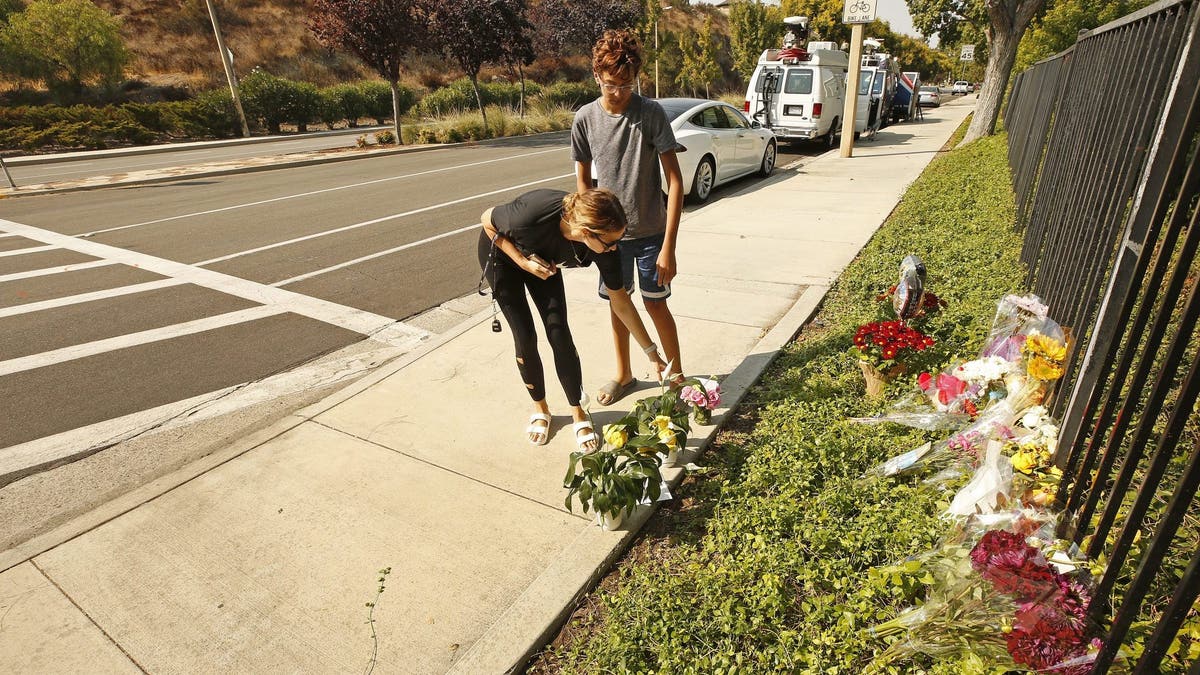 Mourners place flowers at the LA intersection where Rebecca Grossman killed two young boys while speeding