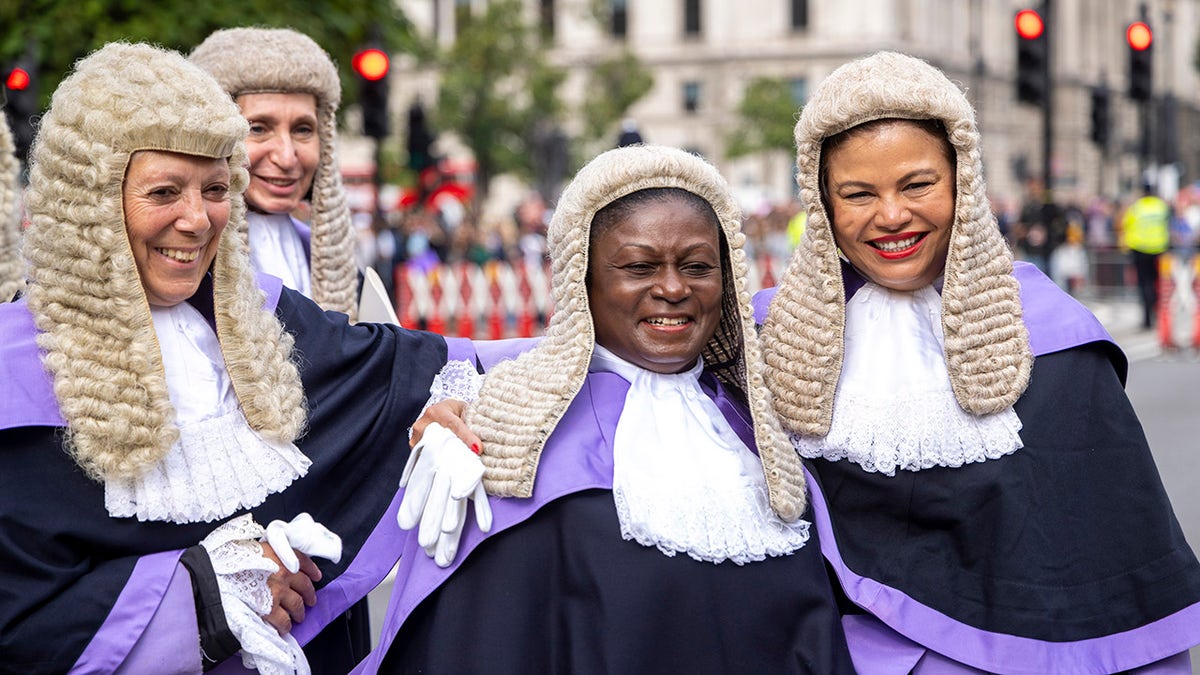 Female barristers smile in wigs at King's Counsel ceremony