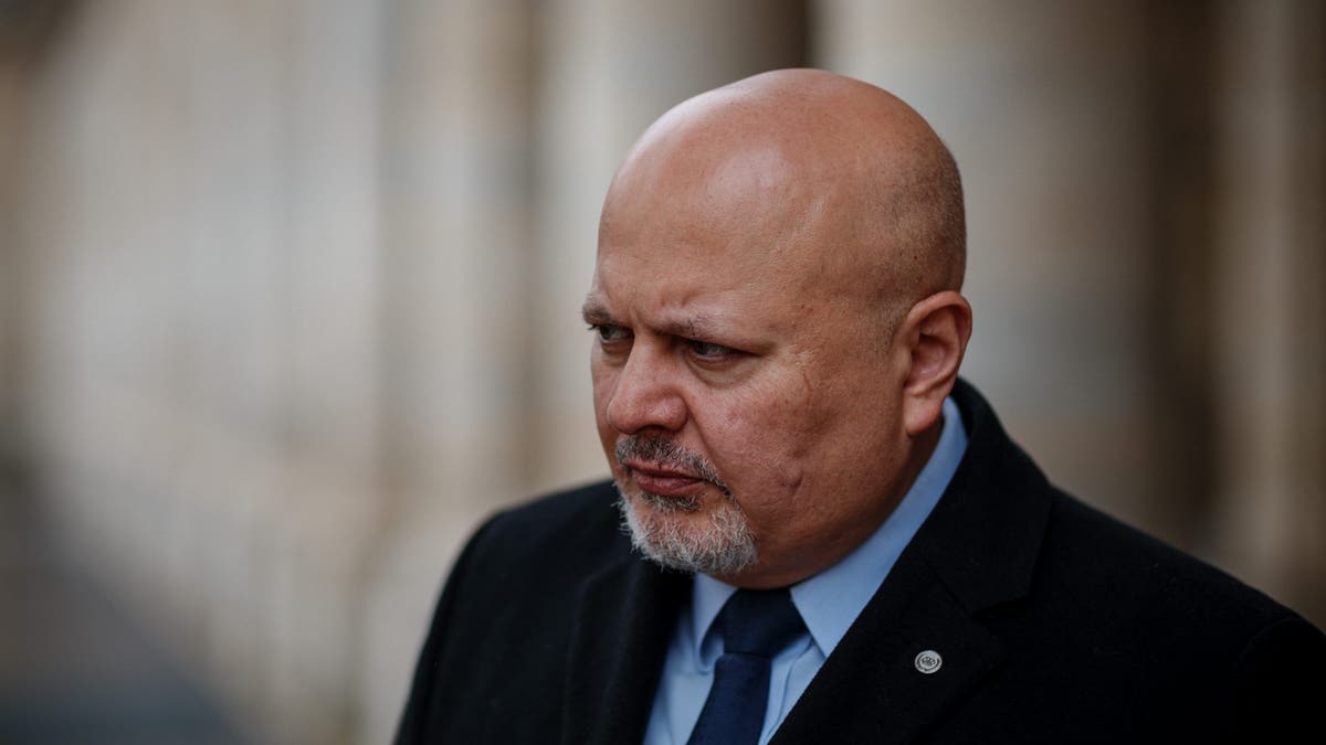 Karim Khan looked serious in a suit and tie