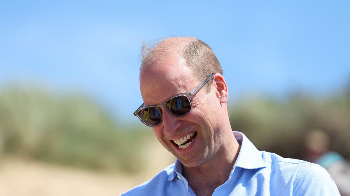 Prince Harry smiling in sunglasses