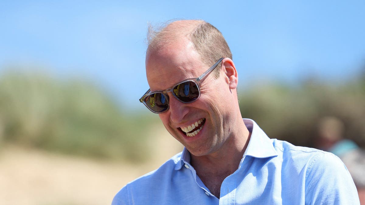 Prince Harry smiling in sunglasses