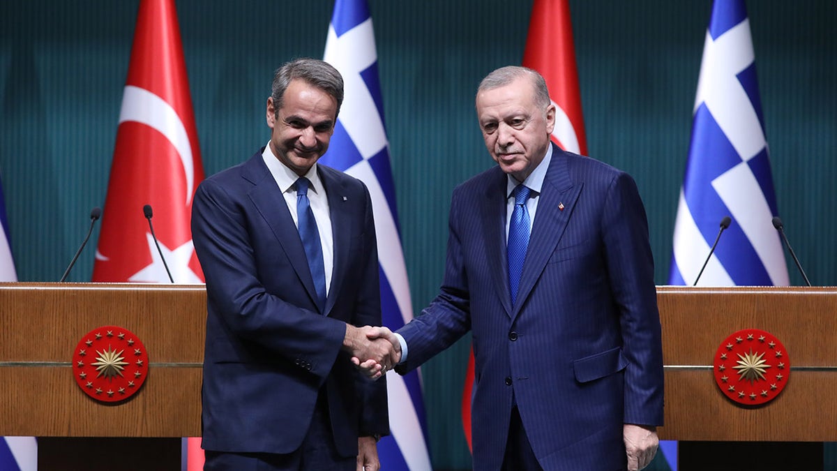 Erdogan and Greek prime minister shake hands