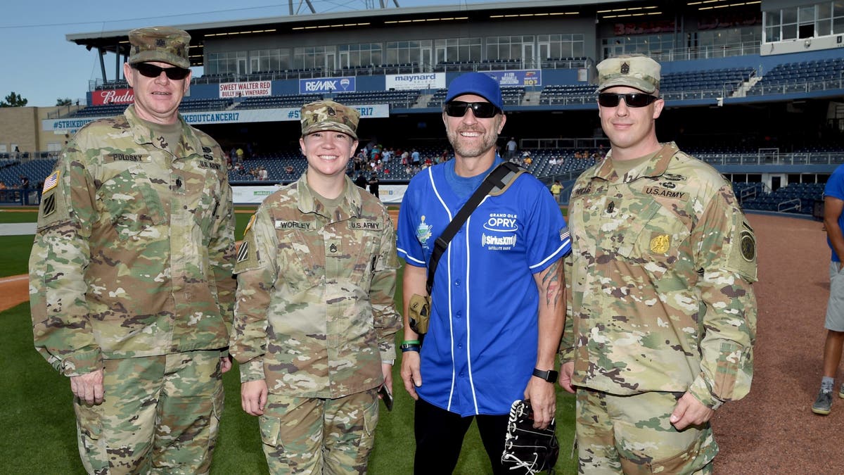 craig morgan with members of the military at softball game