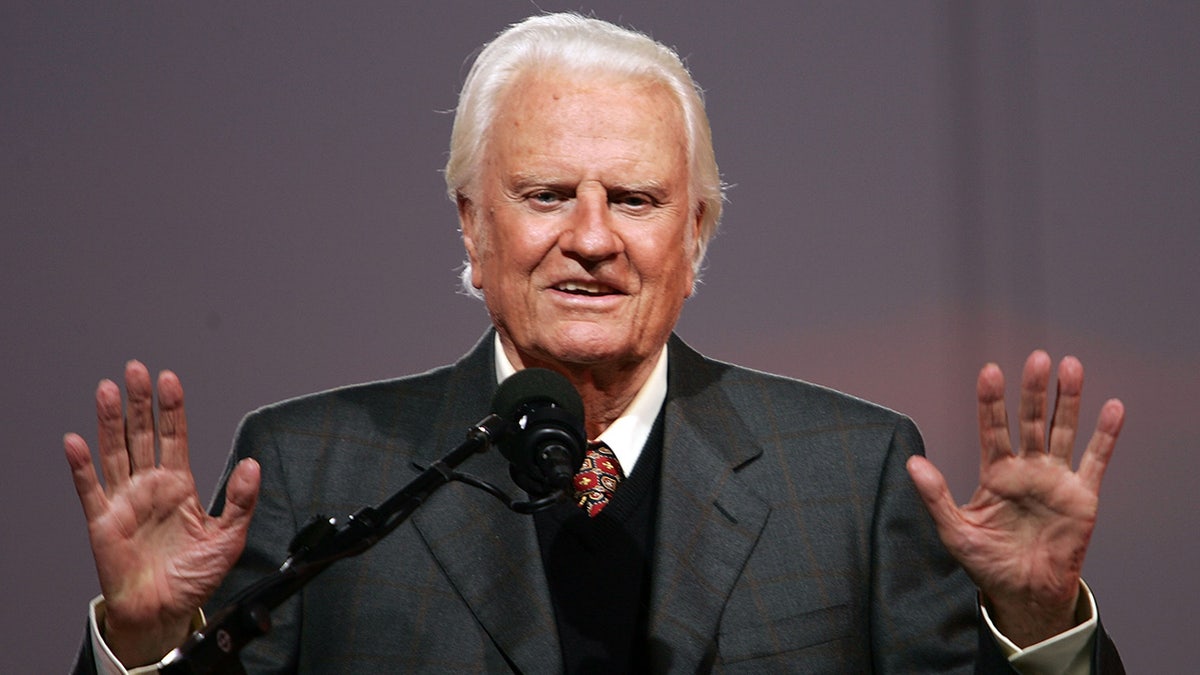 Rev. Billy Graham speaking at a podium